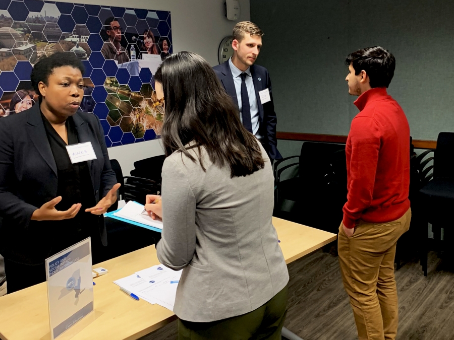 Students and employers talking at the Policy and Social Impact Showcase.