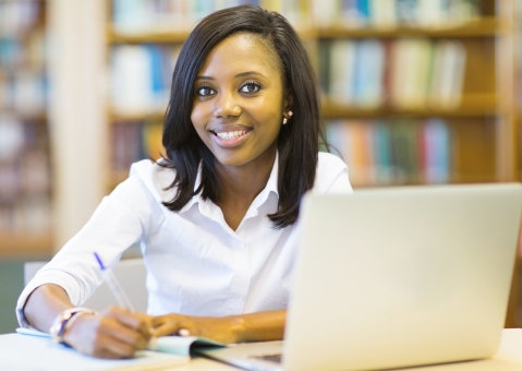 African American student sitting in college library