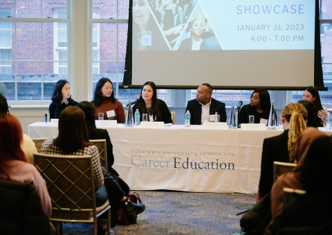 Five women and one man sit on a panel in front of a packed audience of students at the 2023 Diversity Recruiting Showcase on January 31, 2023