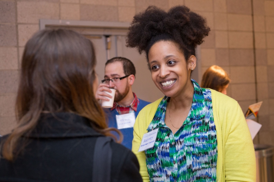 Employer smiling at student in conversation at career fair