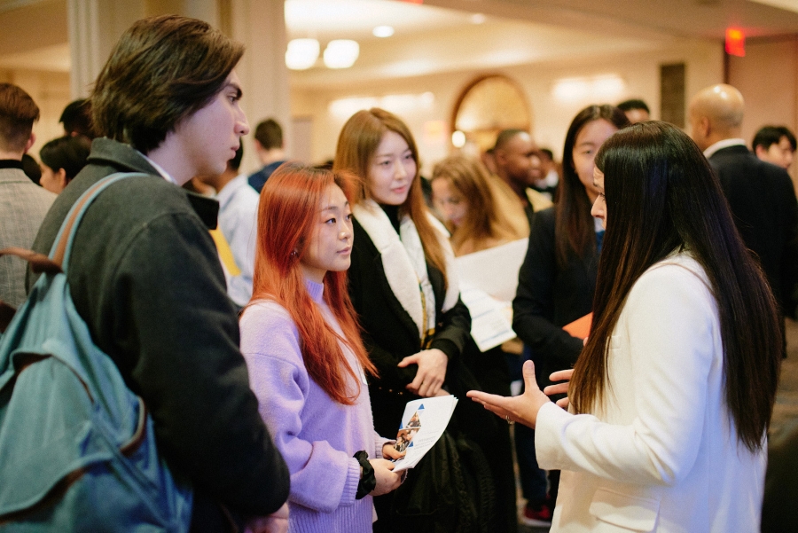 Female recruiter talks to three Columbia students at the 2023 Diversity Recruiting Showcase