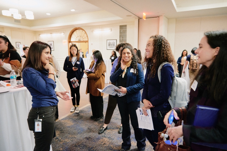 A female recruiter addressing a group of three Columbia undergraduate students at the 2023 Diversity Recruiting Showcase