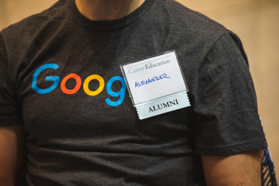 Person's chest with Google T-Shirt and alumni badge.
