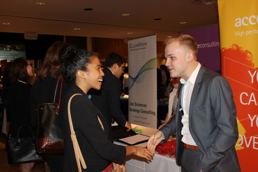 Student and employer shaking hands at the Undergraduate Career Fair